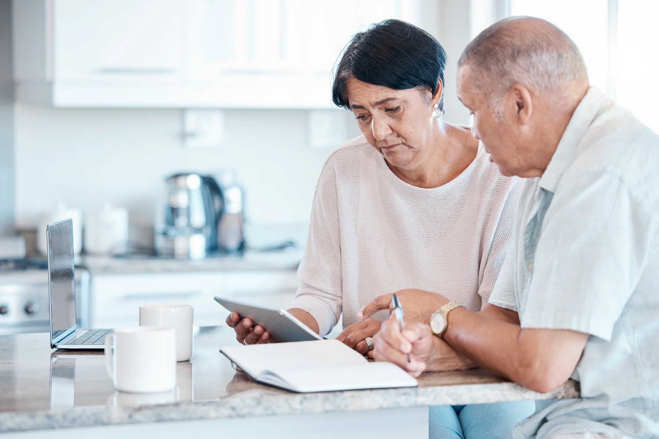 Couple researching on a tablet together at home